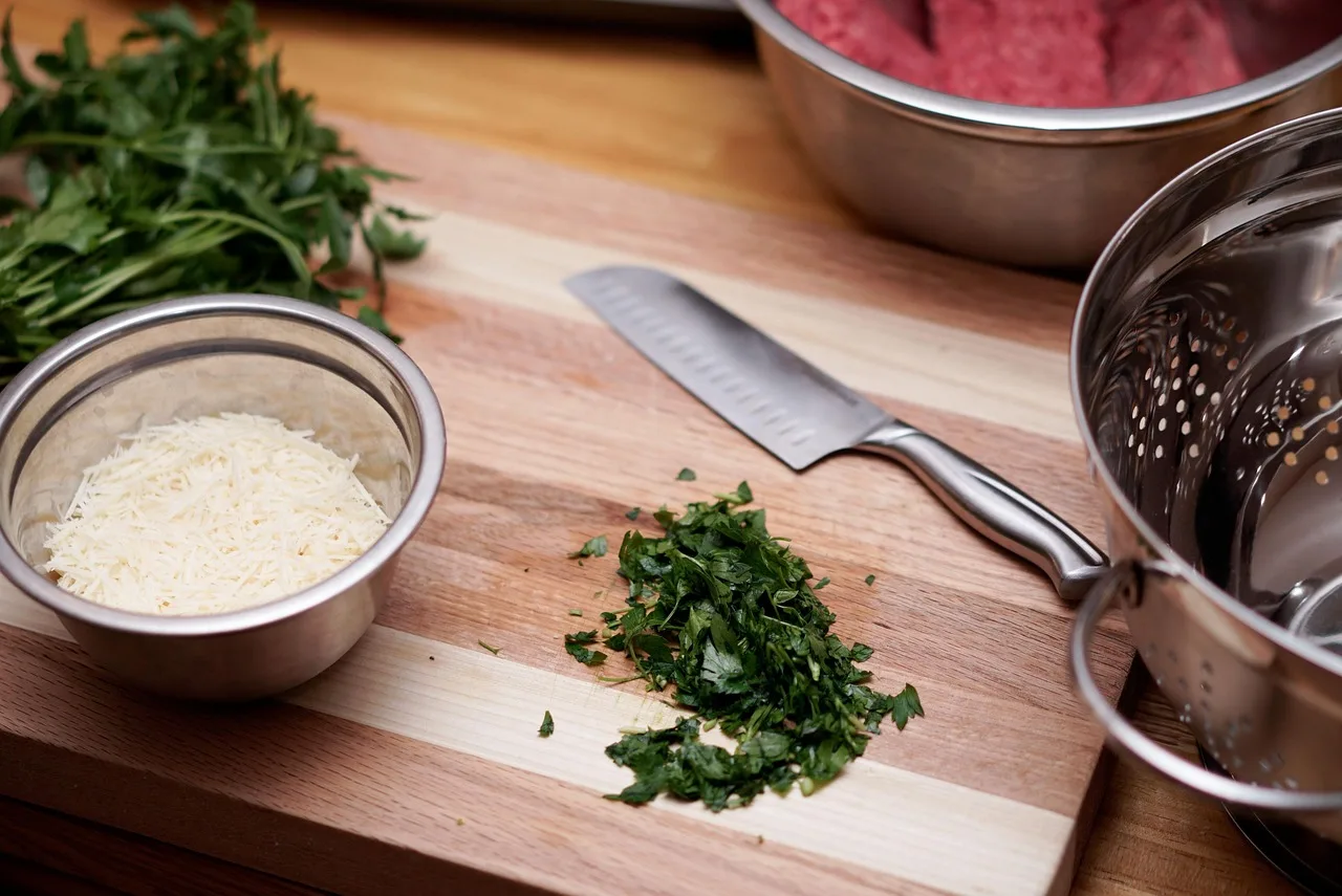 kitchen, cooking, knife, cilantro, mixing bowl, strainer bowl, strainer, kitchenware, parmesan, shredded cheese, shredded parmesan, cutting board, wood cutting board, kitchen, kitchen, kitchen, kitchen, cooking, cooking, cooking, cooking, cooking, knife, cutting board. Commercial Kitchen Rental Cost Canada: Planning Ranges and Lease Terms